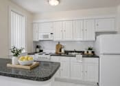 Thumbnail 6 of 18 - A kitchen with white cabinets and appliances.