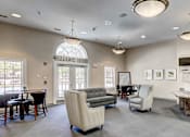 Thumbnail 14 of 17 - the lobby of a clubhouse with a bar and chairs at Windsor Crossing, Maryland 