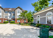 Thumbnail 8 of 17 - a large courtyard with benches and picnic tables in front of an apartment building at Windsor Crossing, Suitland 