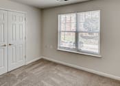 Thumbnail 4 of 17 - an empty bedroom with a window and a door at Windsor Crossing, Suitland, MD 20746 