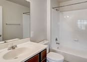 Thumbnail 17 of 17 - a bathroom with a sink toilet and a shower at Windsor Crossing, Suitland, 20746 