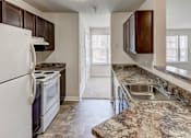 Thumbnail 1 of 17 - a kitchen with white appliances and granite counter tops at Windsor Crossing, Maryland, 20746