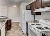 Thumbnail 2 of 17 - a kitchen with a stove and a refrigerator at Windsor Crossing, Suitland, MD 20746 