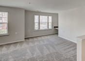 Thumbnail 10 of 17 - the living room and dining room of an empty house at Windsor Crossing, Suitland, MD 