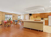 Thumbnail 11 of 29 - A kitchen with wooden floors and a white refrigerator.