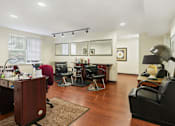 Thumbnail 7 of 29 - A room with a desk, chairs, and a mirror.