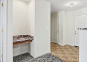 Thumbnail 25 of 29 - A room with a marble countertop and a tiled floor.