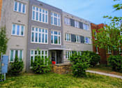 Thumbnail 2 of 14 - a large building with a sidewalk in front of it