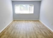 Thumbnail 6 of 13 - an empty room with wood floors and a window at Retreat at Savannah, Savannah, Georgia