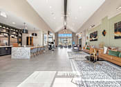 Thumbnail 21 of 44 - A spacious interior of a modern building with a long hallway and a kitchen area.