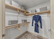 Thumbnail 7 of 44 - A blue robe is hanging on a hanger in a closet.
