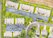 Thumbnail 16 of 21 - A residential area with houses and a parking lot.