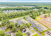 Thumbnail 14 of 21 - A bird's eye view of a residential area with houses and a parking lot.