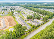 Thumbnail 15 of 21 - A bird's eye view of a residential area with houses and roads.
