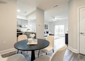 Thumbnail 4 of 20 - A dining room with a table set for two.