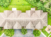 Thumbnail 28 of 31 - A large building with a flat roof and a parking lot in front.
