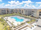 Thumbnail 34 of 44 - A swimming pool in a residential area surrounded by apartment buildings.