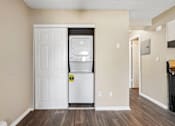 Thumbnail 17 of 22 - A white door is open to a small kitchen with a white fridge.
