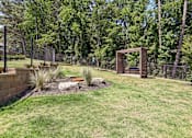 Thumbnail 40 of 40 - A backyard with a fence, a small tree, and a small garden.