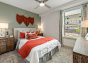 Thumbnail 15 of 44 - A bedroom with a bed, nightstands, and a window with blinds.