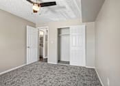 Thumbnail 11 of 22 - A room with a ceiling fan and two doors.
