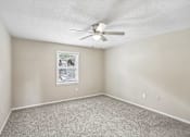 Thumbnail 13 of 37 - A room with a ceiling fan and a window with blinds.
