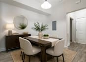 Thumbnail 11 of 31 - A dining room with a wooden table and white chairs.