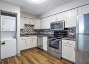 Thumbnail 1 of 15 - Kitchen with white appliances and wooden floors at Summit Terrace, South Portland, 4106