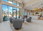 Thumbnail 25 of 44 - A spacious living room with grey armchairs and a large window overlooking a construction site.