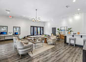Thumbnail 36 of 37 - A modern living room with a grey sofa set and a wooden floor.