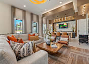 Thumbnail 27 of 44 - A living room with a grey couch and a wooden coffee table.