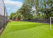 Thumbnail 22 of 37 - A tennis court surrounded by a black fence.
