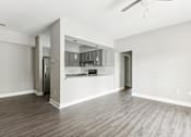 Thumbnail 11 of 18 - A spacious kitchen with a refrigerator, cabinets, and a countertop is visible.