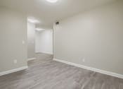 Thumbnail 6 of 27 - A room with light grey flooring and white walls.