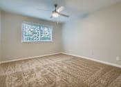 Thumbnail 4 of 27 - A room with a ceiling fan and a window with blinds.