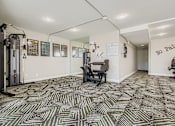 Thumbnail 14 of 27 - A room with a patterned carpet and a sign that says "No Pain" on the wall.