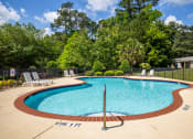 Thumbnail 3 of 18 - a resort style pool with chairs and a fence around it