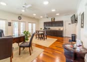 Thumbnail 6 of 18 - a living room with a dining room and a kitchen