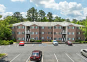 Thumbnail 8 of 18 - an empty parking lot with cars in front of an apartment building