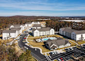 Thumbnail 22 of 27 - an aerial view of a large hotel complex with a swimming pool and parking lot