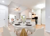 Thumbnail 14 of 37 - a dining area with a table and chairs and a kitchen in the background  at Avenues of Kennesaw East & West, Kennesaw, 30144