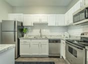 Thumbnail 2 of 37 - a renovated kitchen with white cabinets  at Avenues of Kennesaw East & West, Kennesaw, 30144