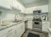 Thumbnail 1 of 37 - a renovated kitchen with stainless steel appliances  at Avenues of Kennesaw East & West, Kennesaw