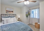 Thumbnail 3 of 14 - a bedroom with two beds and a ceiling fan and a window