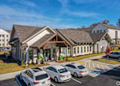 Thumbnail 20 of 27 - a building with a parking lot in front of it