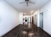 Thumbnail 16 of 27 - a living room with white walls and a ceiling fan