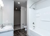 Thumbnail 15 of 27 - a bathroom with a white bathtub and a white sink