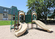 Thumbnail 22 of 30 - A playground with a slide and a climbing frame.