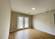 Thumbnail 18 of 26 - Living room with practical hardwood flooring at Oasis at Cedar Branch in Wilmington, NC