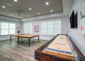 Thumbnail 10 of 25 - a games room with a shuffleboard table and a foosball table  Flyer at Century Avenues, Lakeland, FL, 33813